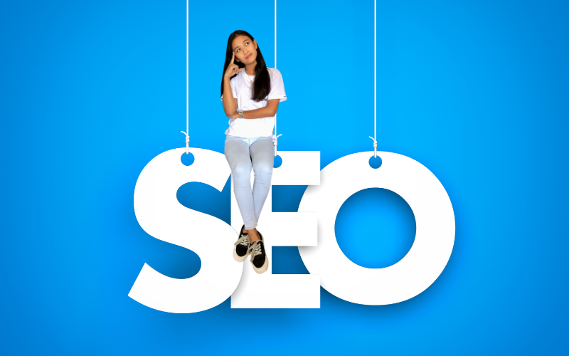 SEO for Business Startup - woman sitting on big SEO letters